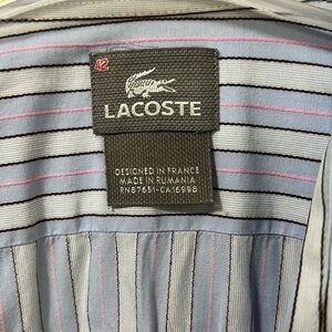 Lacoste light blue with black and pink stripes .
Long sleeve dresss shirt